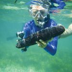 Lydia Edwards ’19 examines a specimen during a scuba diving excursion in San Salvador.