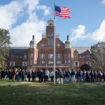 Students, faculty, and staff gathered in front of Main Hall