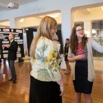 Students explain their work at the poster presentation in the Hampson Commons