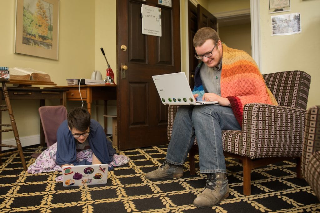 Lewis Ward '20 and Stephen Krueger, access and outreach services librarian at Randolph, work together in the Lipscomb Library.