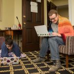 Lewis Ward '20 and Stephen Krueger, access and outreach services librarian at Randolph, work together in the Lipscomb Library.