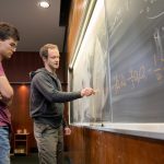 Jude Quintero '20 (left) and mathematics professor Michael Penn work on an equation