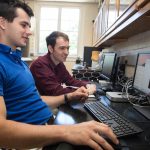 Yuriy Snyder '19 (left) and chemistry professor Jesse Kern test a molecule using computational modeling software