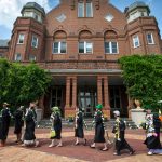 Students carry the Daisy Chain past Main Hall