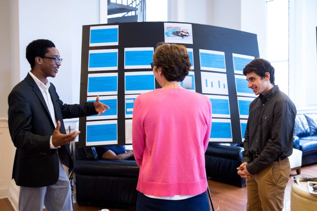 Josh Yeast '19 (left) and Damien Douglas present a poster about the project, 