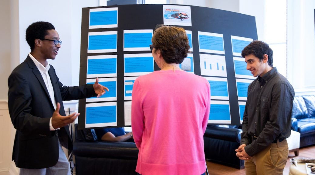 Josh Yeast '19 (left) and Damien Douglas present a poster about the project, "Teaching Math and Science in a Changing World."