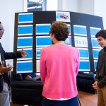 Josh Yeast '19 (left) and Damien Douglas present a poster about the project, 