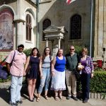 Group of students and professors stand in front of a Bulgarian monument