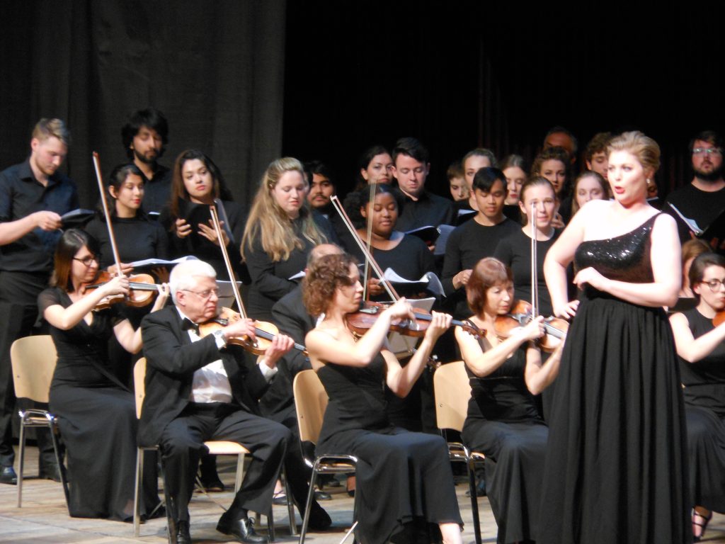 Lindsay Mohler '18, Cristina Evans '18, and Helena Zirkle '20 (all in the back) participate in one of the orchestral performances