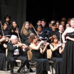 Lindsay Mohler '18, Cristina Evans '18, and Helena Zirkle '20 (all in the back) participate in one of the orchestral performances