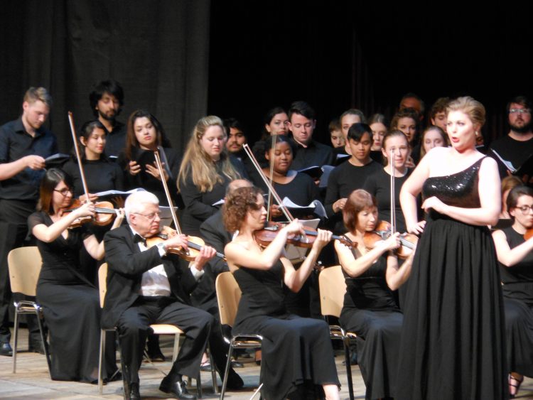 Lindsay Mohler '18, Cristina Evans '18, and Helena Zirkle '20 (all in the back) participate in one of the orchestral performances Lindsay Mohler '18, Cristina Evans '18, and Helena Zirkle '20 (all in the back) participate in one of the orchestral performances