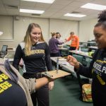 Students stack metal nuts in a task aimed at teaching arousal regulation, which helps teach breathing techniques to improve performance on fine motor skills. The activity was part of professor Meghan Halbrook’s Sport Psychology class.