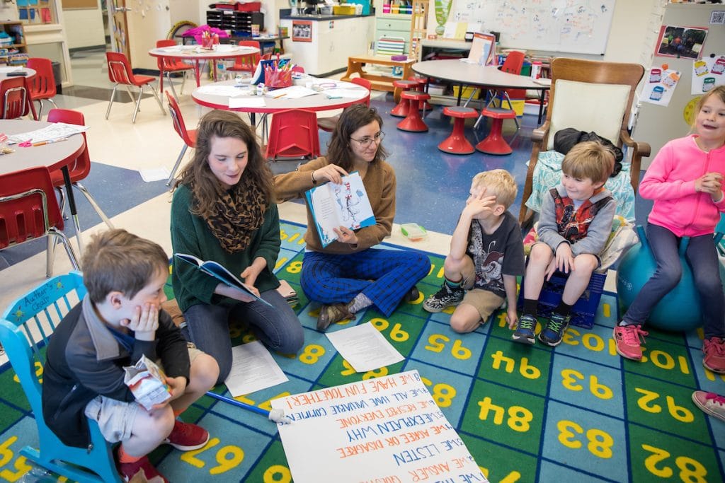 Faith Powell ’18 (middle left) and Lydia Hamd ’18 (middle right) read The Cat in the Hat to students at James River Day School.