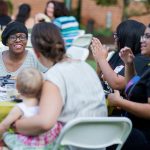 Students and alumnae have conversations over dinner at the College Community Cookout