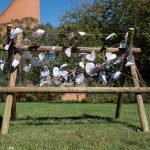 Students wrote heart-shaped messages on a fence in Bell Quad as part of the commemorative service for Matthew Shepard.