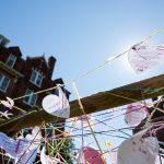 Students wrote heart-shaped messages on a fence in Bell Quad as part of the commemorative service for Matthew Shepard.