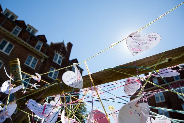 Students wrote heart-shaped messages on a fence in Bell Quad as part of the commemorative service for Matthew Shepard. Students wrote heart-shaped messages on a fence in Bell Quad as part of the commemorative service for Matthew Shepard.
