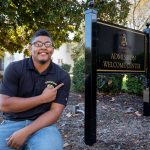 Corey Brown '16 in front of Randolph's Admission Welcome Center