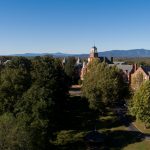 Aerial photo of campus with the blue sky and mountains in the background