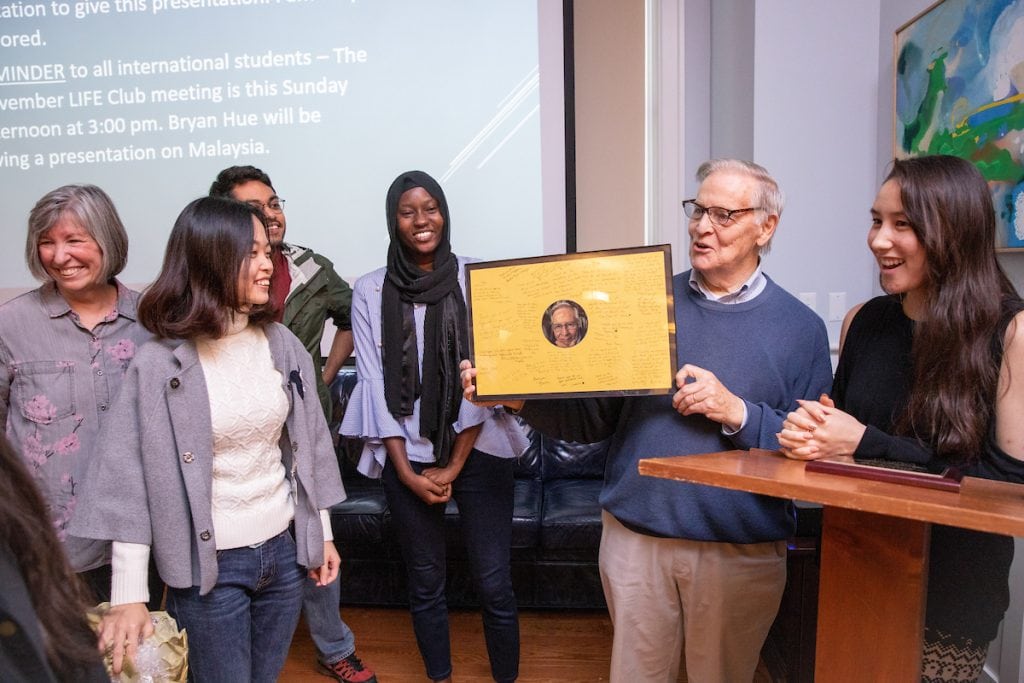 Vic Uotinen receives a framed photo with international student signatures Vic Uotinen receives a framed photo with international student signatures