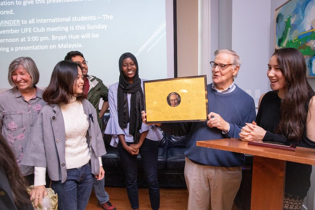 Vic Uotinen receives a framed photo with international student signatures