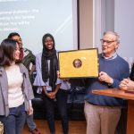 Vic Uotinen receives a framed photo with international student signatures