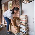 Maya Wheeler ’19 sorts through used books donated to the Rummage Room.