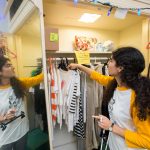 organizes the clothing selection in the Rummage Room.