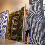 Elisabeth Ayars '19 sets up paintings for the spring exhibitions that will open this Friday.