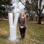 Rikki Carretta '19 next to the Odd Tree on front campus