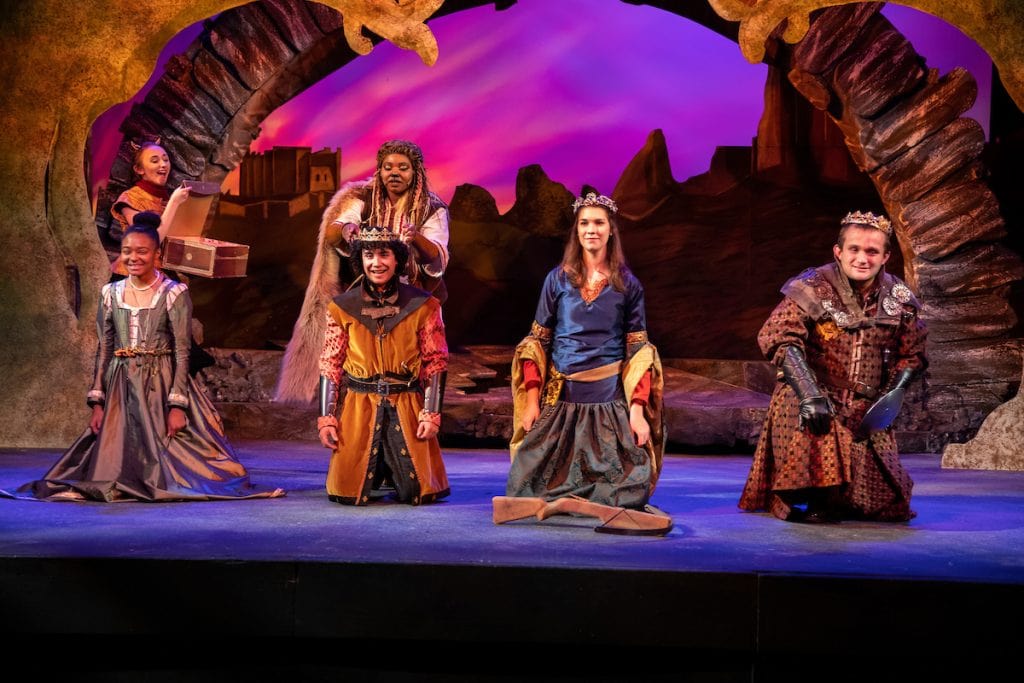 Liz Beamon '20 (second from left, standing) and Ho'ola Bush '20 (second from left, kneeling) on stage with other members of The Lion, the Witch, and the Wardrobe cast