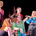Faculty members pamper professor Danielle Currier as part of a skit
