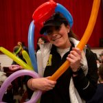 Volleyball coach Kara Matthews and other members of the athletic department make balloon animals for students