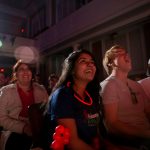 Students in the audience cheer for the performers