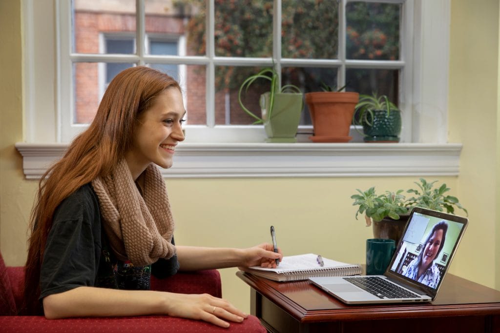 Student talking to professor through a chat window on a laptop