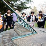 Students sing school songs around the Sundial