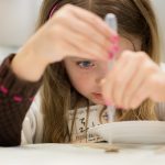 Child participating in science activities during the 2018 Science Festival