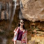 Student in front of a waterfall