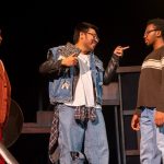Male characters interact in the play