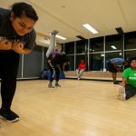 Team members practice a routine in the aerobics room
