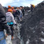 Students in hiking gear on top of a glacier