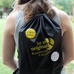 A Randolph College student shows off her Be An Original backpack and button collection.