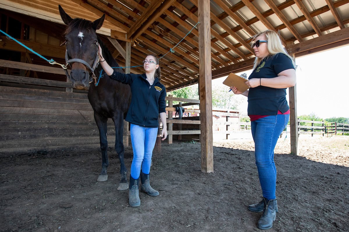 Sidney Clark and biology professor Amanda Rumore examine one of their test subjects