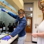 Darius Chernitsky and professor Ann Fabirkiewicz run a sample through a soxhlet extractor