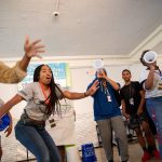 Students and mentors practice chants in Smith Banquet Hall