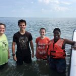 (From left) professor Sarah Sojka, Alex Kulvivat, Paige Edwards, and Jdody Misidor in the water along the eastern shore of Virginia.