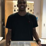 Brian Smith holds a case of beetle and weevil specimens as part of his internship at the Smithsonian Museum of Natural History