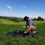 Mitchell Doss prepares a DJI Matrice 100 drone for take-off