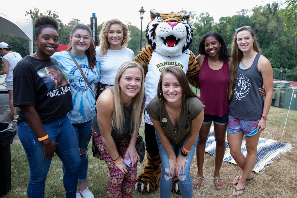 Alumnae pose with Wanda WildCat during the tailgate event