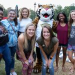 Alumnae pose with Wanda WildCat during the tailgate event